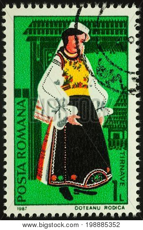 Moscow Russia - August 07 2017: A stamp printed in Romania shows young woman in Romanian national costume Tirnave region series 