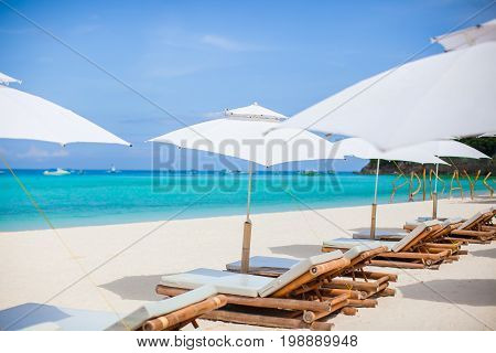 Beach chairs on exotic tropical white sandy beach