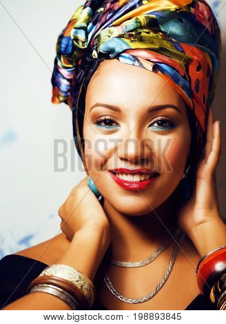 beauty bright real african woman with creative make up, shawl on head like cubian closeup smiling