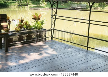 Wooden bench in a water house garden stock photo