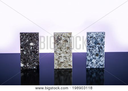 Granite, Granite counter tops. Kitchen granite counter samples. Three granite counter top stones on glossy surface