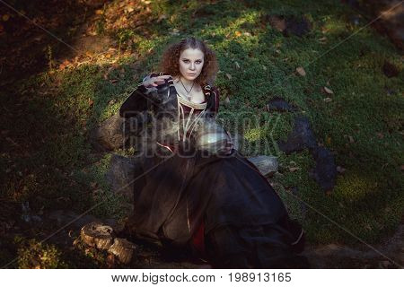 Woman is engaged in magic she cooks a magic potion.