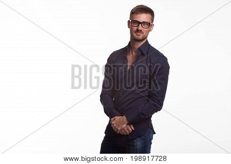 Young jocular man portrait of a confident businessman on a gray background. Ideal for banners, registration forms, presentation, landings, presenting concept.