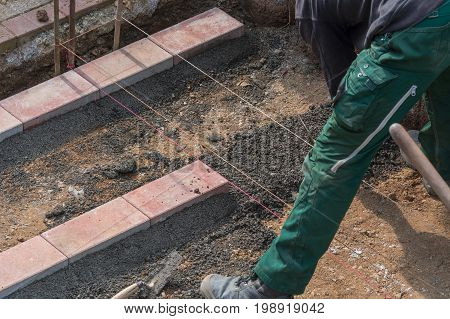 Close up construction worker in making a bricklayer from bricks on construction site.