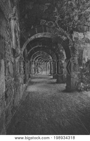 Internal passages in the ancient Roman amphitheater of Aspendos. The province of Antalya. Mediterranean coast of Turkey. Black and white. Stylization.