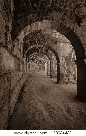Internal passages in the ancient Roman amphitheater of Aspendos. The province of Antalya. Mediterranean coast of Turkey. Sepia. Toning. Stylization.