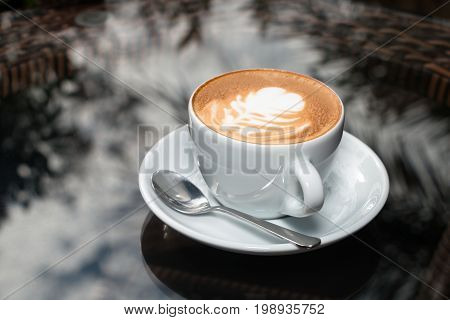 a Cup of coffee on table background.