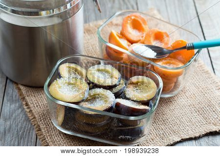 Frozen apricots and plums covered with sugar