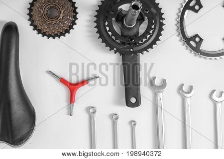 Bicycle parts and repair tools on white background