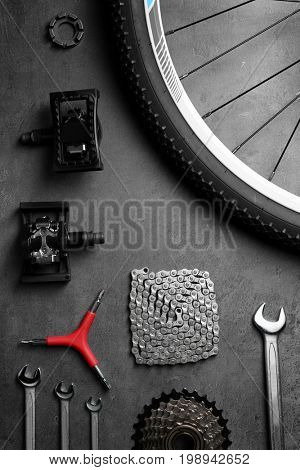 Bicycle parts and repair tools on gray background