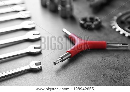 Bicycle parts and repair tools on gray background