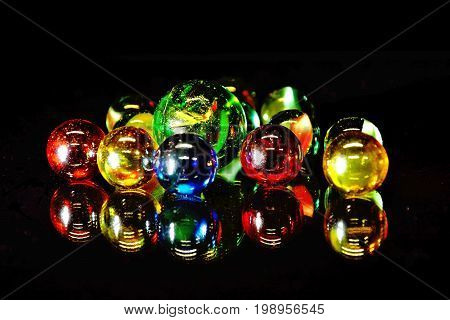 Mirrored colourful glass beads on black background