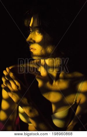 The body of nude woman with color pattern in the beam projector