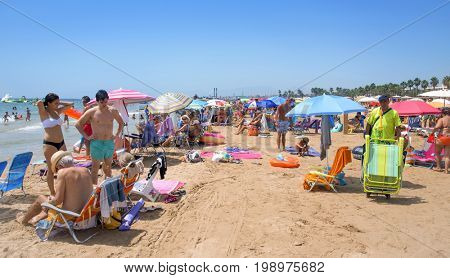 SALOU, SPAIN - AUGUST 3, 2017: Vacationers in the Llevant Beach in Salou, Spain. Salou is a major destination for sun and beach for European tourism, with more than 50,000 accommodations