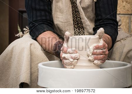 Hands of the old master at work
