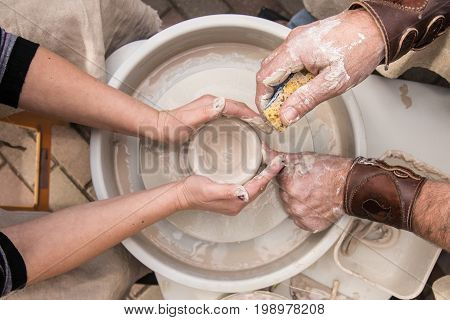 Hands of the old master at work
