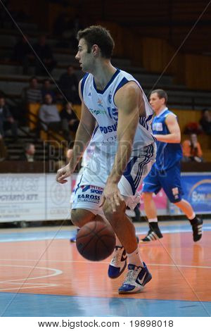 KAPOSVAR, HUNGARY - MARCH 19: Dan Werner (in white) in action at a Hungarian National Championship basketball game Kaposvar vs Debrecen March 19, 2011 in Kaposvar, Hungary.