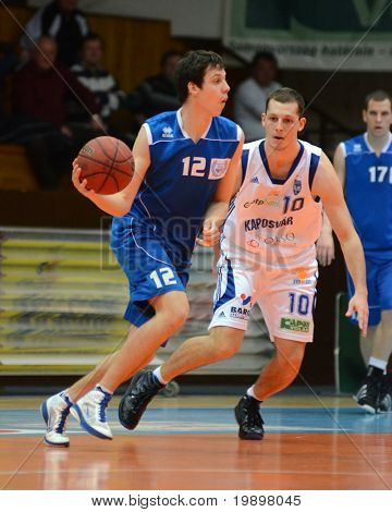 KAPOSVAR, Ungheria - 19 marzo: Mate Medve (10) in azione in un campionato nazionale ungherese basketb