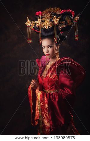 Woman in Chinese tradition dress. Queen red dress