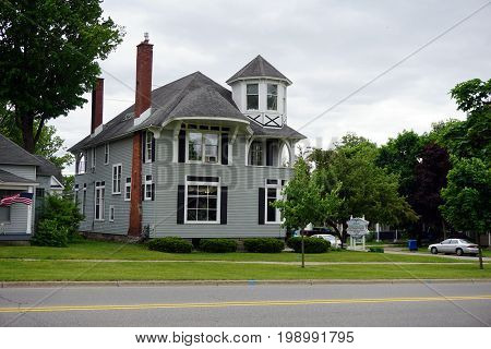 CADILLAC, MICHIGAN / UNITED STATES - MAY 31, 2017: The Cadillac Chiropractic Center, P.C., offers chiropractic treatment in a mansion in  in Cadillac's Courthouse Hill Historic District.