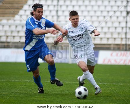 KAPOSVÁR, Hungria - 16 de abril: Benjamin Balazs (R) em ação em um Campeonato Nacional Húngaro soc