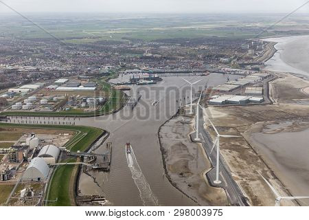 Aerial View Harbor Delfzijl With Wind Turbines And Factories In The Netherlands