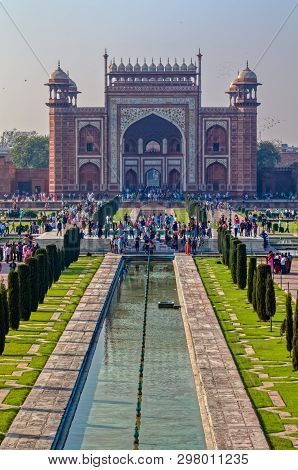 Agra, India - March 5 2018: Tourists Sighteseeing, Exploring And Admiring Famous The Taj Mahal From 