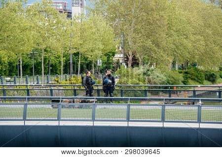 Strasbourg, France - Apr 28, 2019: Two Crs Police Officers Surveilling The Bridge Near European Parl