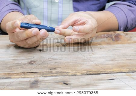Man Taking Blood Sample With Lancet Pen. Diabetes Concept. Medicine, Diabetes, Glycemia, Health Care