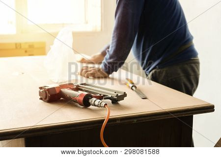 The Carpenter Is Repairing The Table So He Can Use It. Improve The Furniture In The House To Be Beau