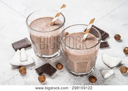 Chocolate Coconut Hazelnut Milkshake Or Smoothie In Two Glasses On White Table.