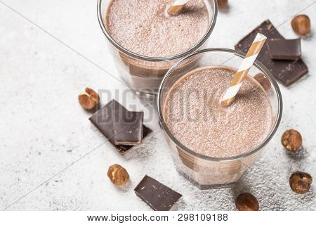 Chocolate Coconut Hazelnut Milkshake Or Smoothie In Two Glasses On White Table. Close Up.