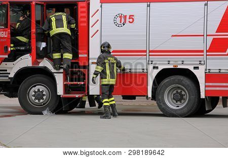 Italia, It, Italy - May 10, 2018:red Fire Truck And Talian Firefighters With Uniform During Fire Dri