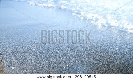 Blurred Photo Of Calm Sea On The Sandy Beach At Brught Sunny Day