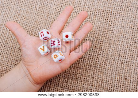 Colorful Alphabet Letter Cubes In Handon A  Canvas Background