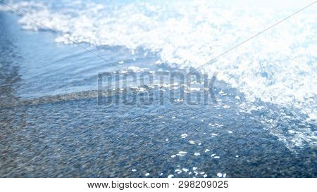 Closeup Shot Of Small Sea Waves At Brught Sunny Day