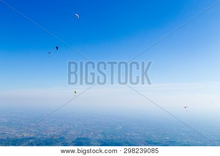 Paraglider On Blue Sky. Borso Del Grappa, Famous Paragliding Site, Italy