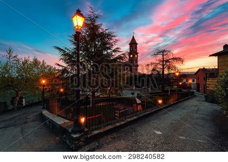 Parish church and houses in small town of Serralunga d'Alba early in the morning in Piedmont, Northern Italy.