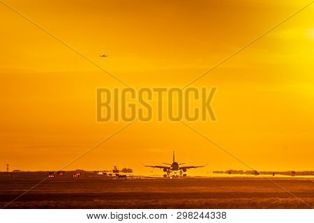 Commercial Airliners Arrive And Depart The Runway On A Hot Evening