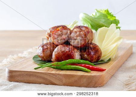 Isaan Sausage Or Thai Northeastern Sausage On A Wooden Table