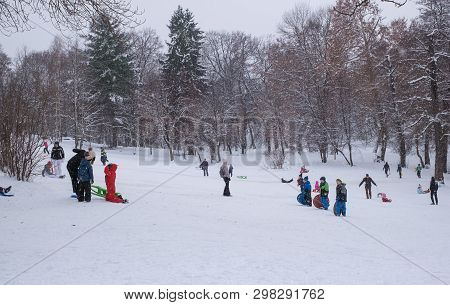 Sibiu City, Romania - January 12, 2019. Group Of Children And Adult Playing On Snow In Winter Time I