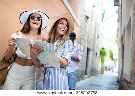 Smiling Gorup Of Friends With Map. Tourism, Travel, Leisure, Holidays And Friendship Concept