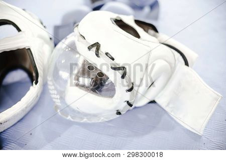 White Protective Helmets With Mask For Martial Arts On The Floor