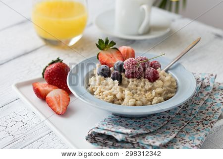 Breakfast Oatmeal Porridge With Fruits Berries And Coffee Cup. Oatmeal With Strawberries And Berry. 