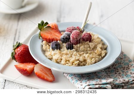 Breakfast Oatmeal Porridge With Fruits Berries And Coffee Cup. Oatmeal With Strawberries And Berry. 