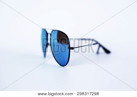 Blue Mirrored Sunglasses With Anti-reflective Coating And Uv Protection On A White Background. Close