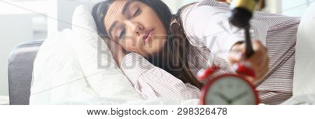 Sleepy Young Woman Portrait With One Opened Eye Trying Kill Alarm Clock. Early Wake Up Not Getting E