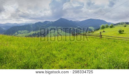 Carpathian Landscape. Fenced Hayfields On A Foreground, Distant Mountain Ranges On A Background Of C
