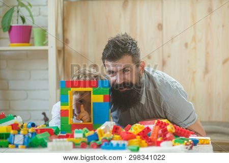 Father And Son Built Window With Plastick Bricks And Now Look Through It. Development Games With Pla