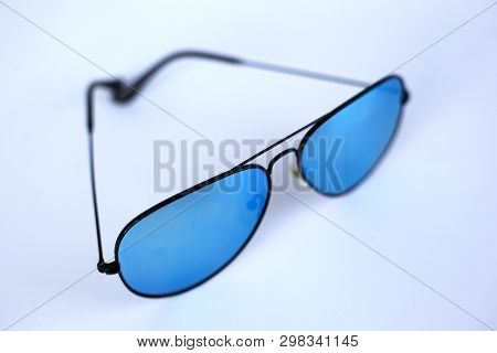Blue Mirrored Sunglasses With Anti-reflective Coating And Uv Protection On A White Background. Close